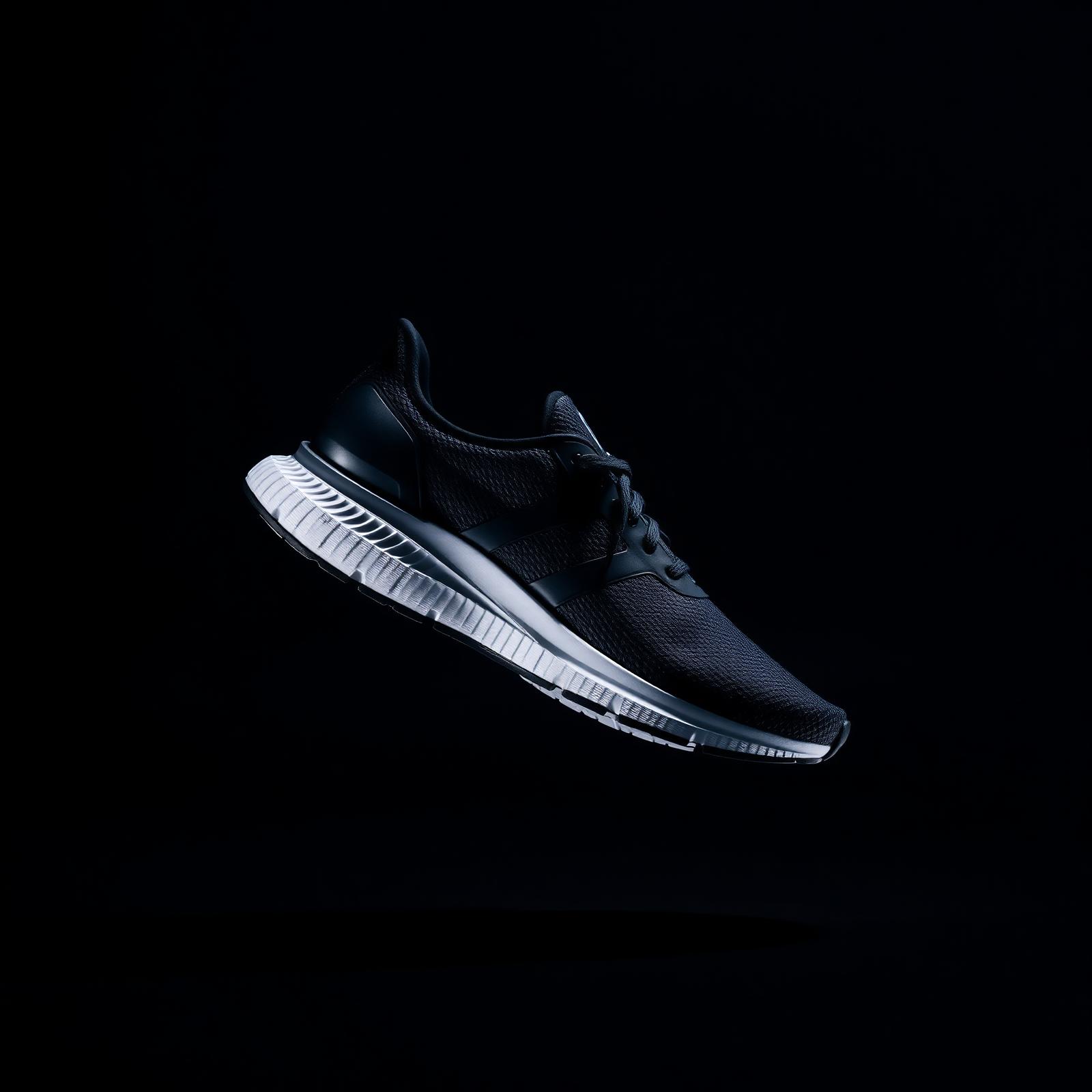 Stride Co. premium sneaker photographed against a dark studio backdrop